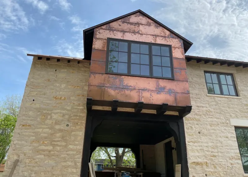Copper metal panel facade on a stone building for Skylight Installation in Palmetto Estates