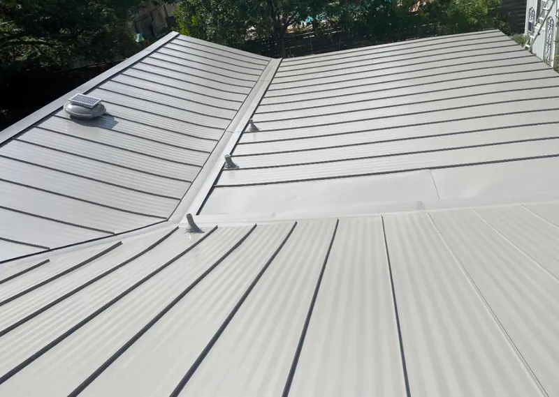 Solar attic fan installed on a metal roof for Roof Ventilation in Palmetto Estates